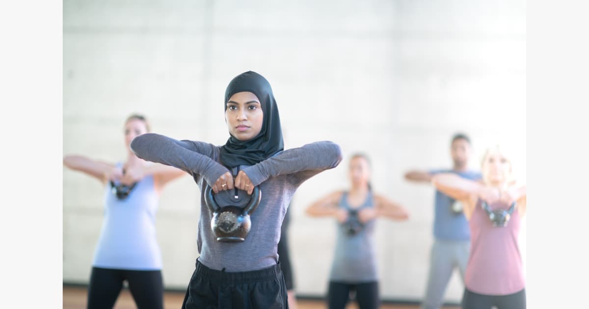 A woman doing gentle yoga, fitting movement into everyday life